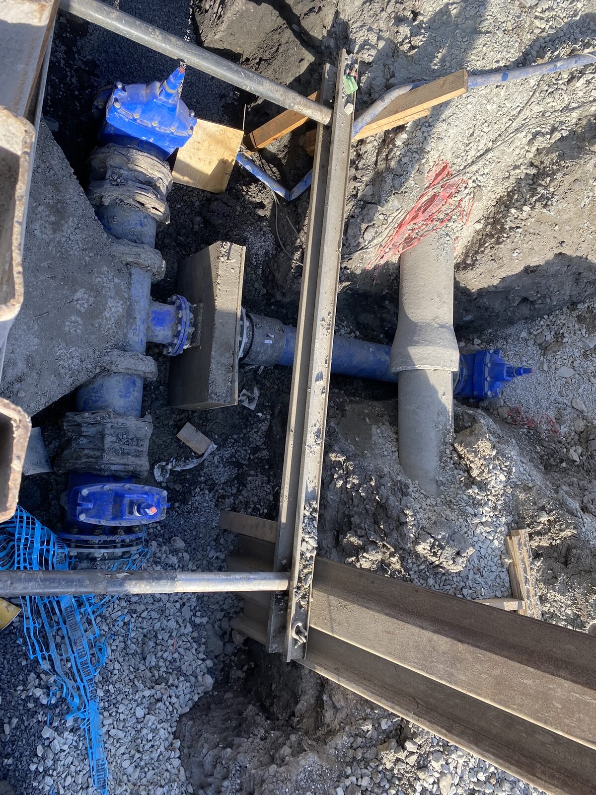 Tee fitting with concrete thrust block on water main